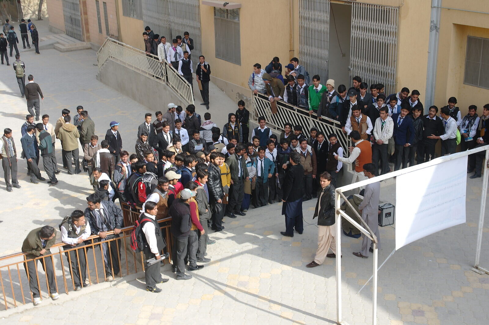 Students queue outside their school