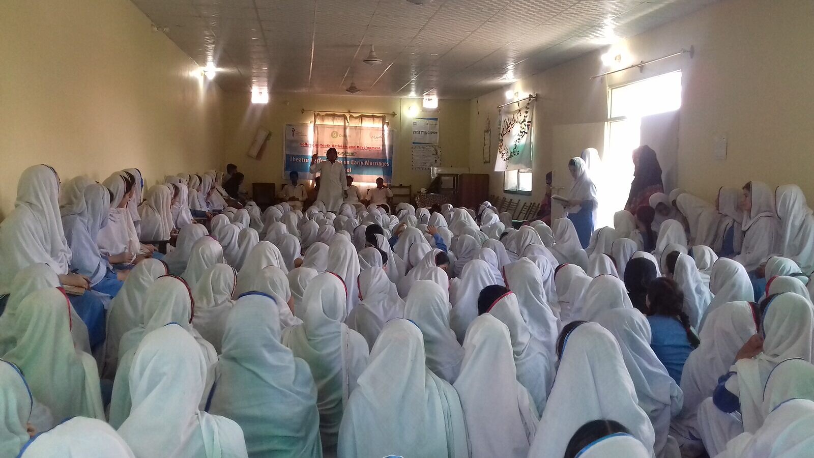 Students attend a theatre performance on early-marriage awareness