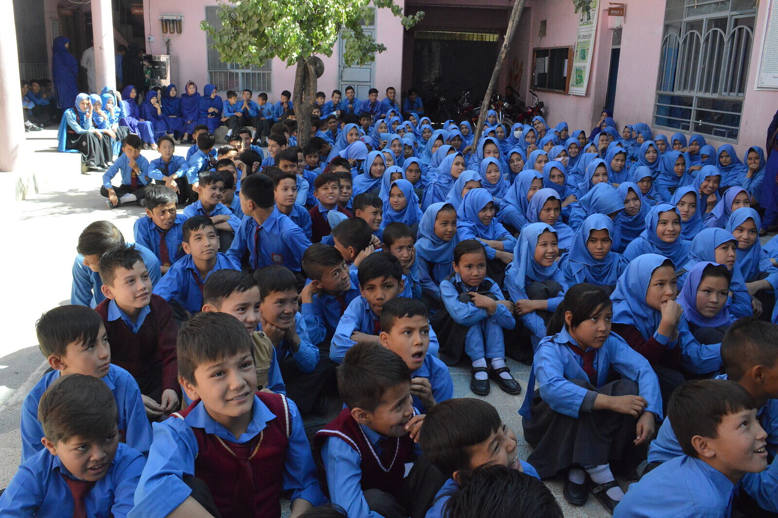 Girls gather in a school courtyard