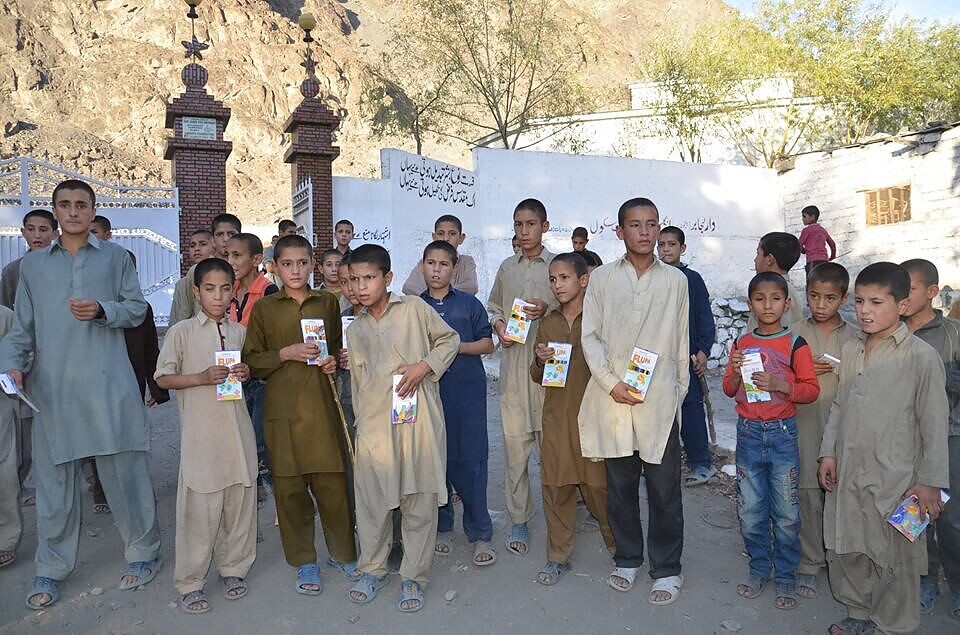 A community gathering with children and learning kits