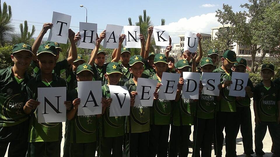 A youth cricket team celebrates together