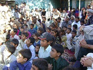 Children and community members gather together